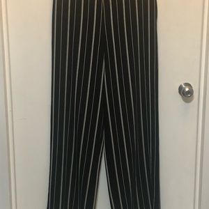 Black palazzo pants with white pinstripes.